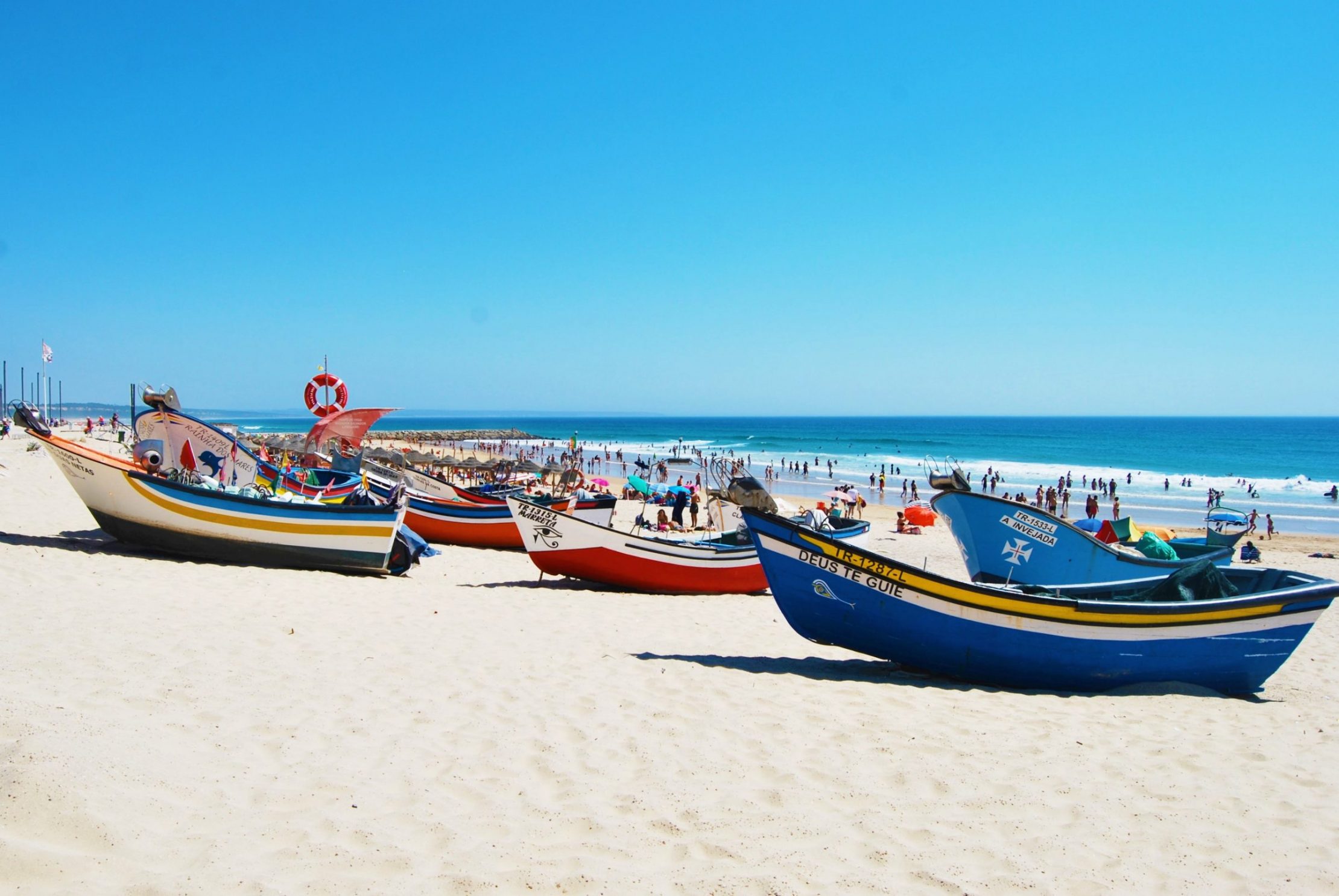Boats on Costa da Caparica beach Portugal