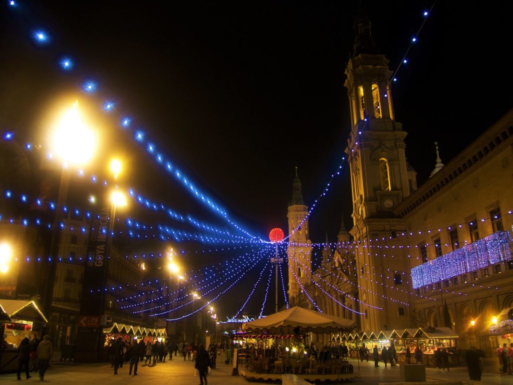 Christmas market in Zaragoza, Spain, with the background on the wonderful Pilar Square