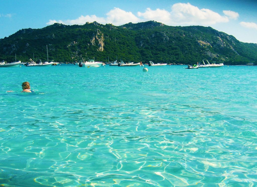 Perfectly cristalline sea just like a swimming pool in Santa Giulia beach in Corsica, France