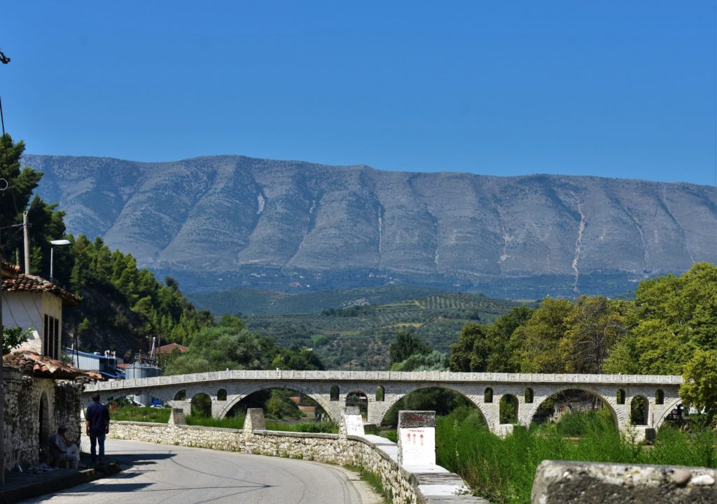 Ottoman bridge and mountain range enclosing Berat with words NEVER, Albania