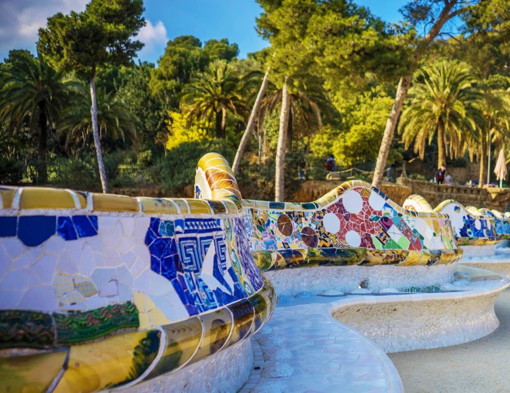 Famous terrace with benches decorated with ceramic mosaic in Parc Güell, Barcelona
